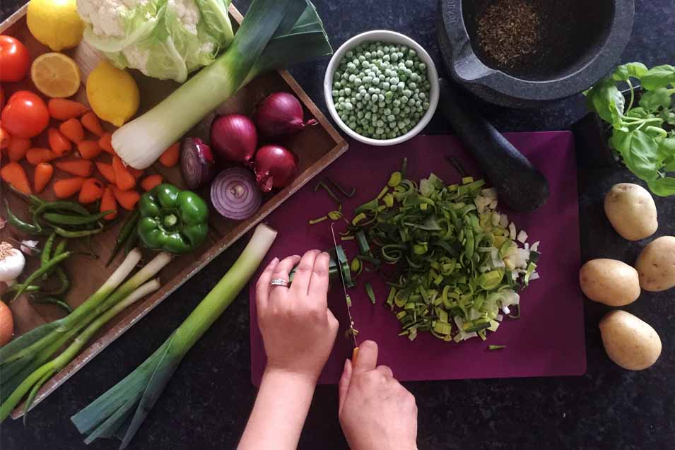 Picture of a woman cutting up vegetables