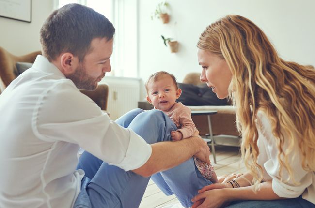 Parents and Crying Baby At Home