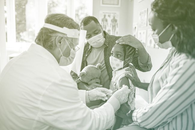 parents with little girl getting vaccinated, everyone wearing face masks