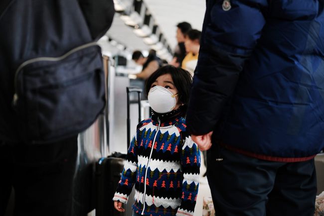 At the terminal that serves planes bound for China, a child wears a medical mask out of concern over the Coronavirus at John F. Kennedy Airport (JFK) out of concern over the Coronavirus on January 31, 2020 in New York City. The virus, which has so far killed over 200 people and infected an estimated 9,900 people, is believed to have started in the Chinese city of Wuhan.