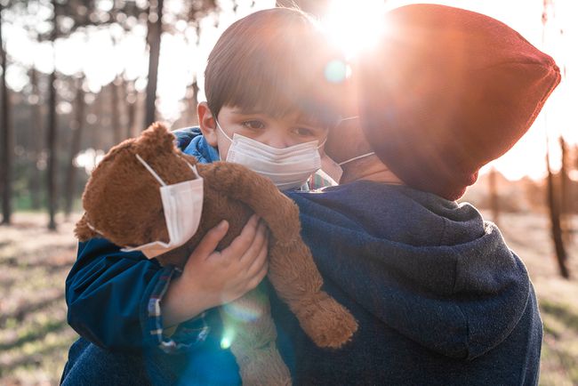 Concerned father and son using air protection masks