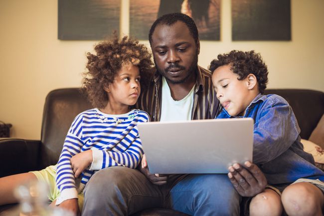 kids using laptop with their father