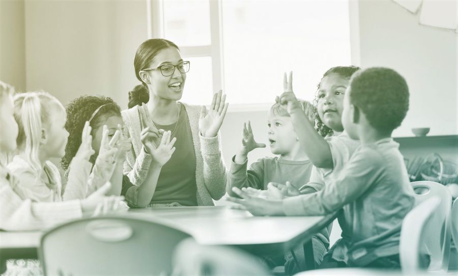 preschool teacher and students in classroom