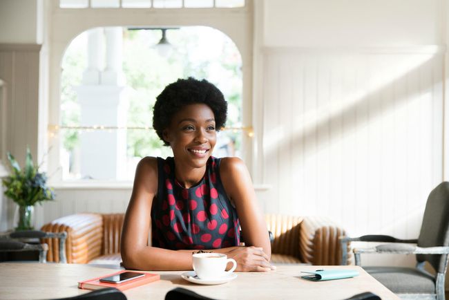 Woman practicing self-care relaxing with coffee