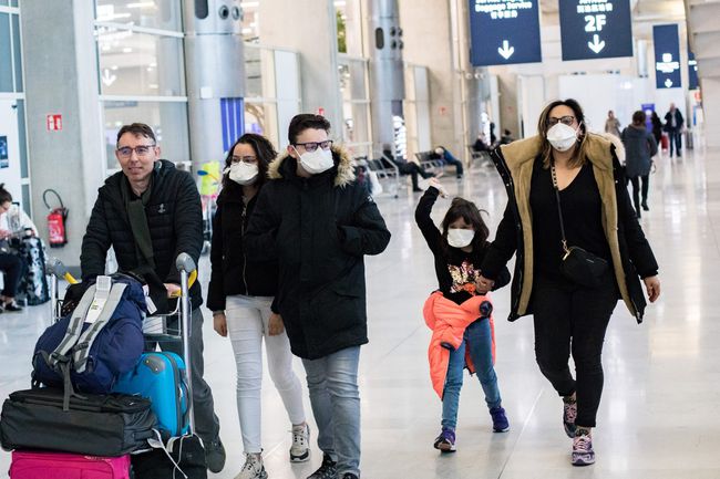 Travellers family wear masks to avoid transmission of coronavirus upon arrival at Terminal 2 of Roissy Charles de Gaulle Airport in Roissy, France, on February 29, 2020.