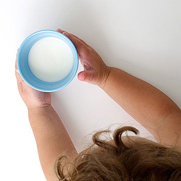 toddler drinking glass of milk