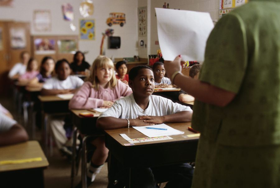 Students listen to a teacher