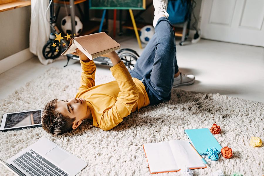 An image of a boy reading a book.