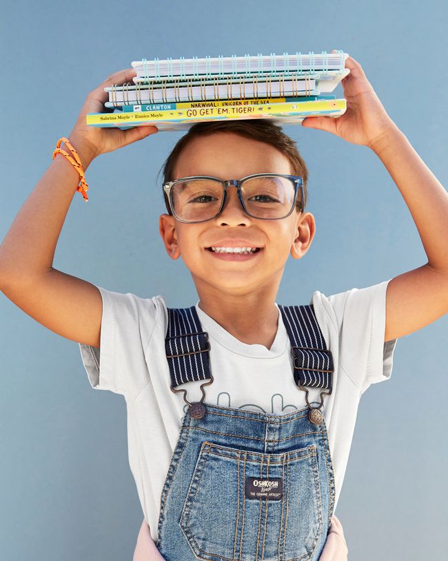 child holding books on head