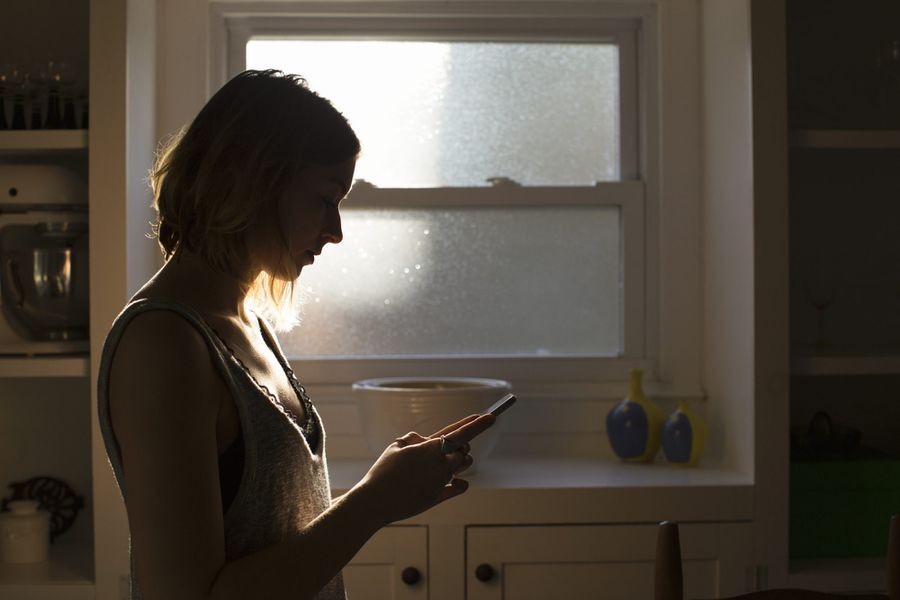 An image of a woman looking at her phone.