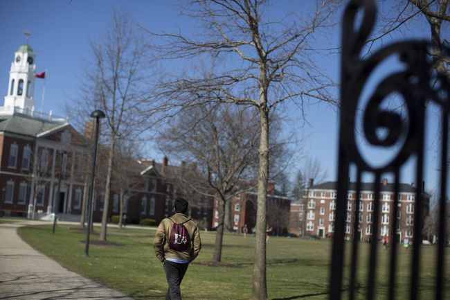 student walking on campus grounds