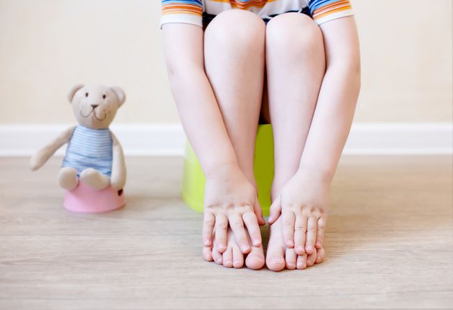 Constipated child sitting on a potty