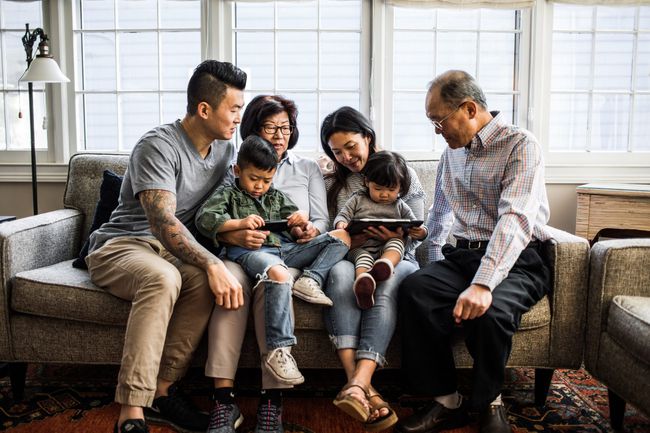 An image of a family sitting on a couch together.