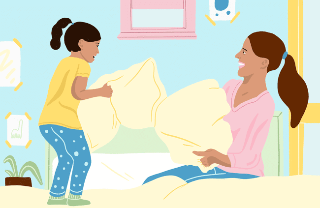 Mom and child have a pillow fight.