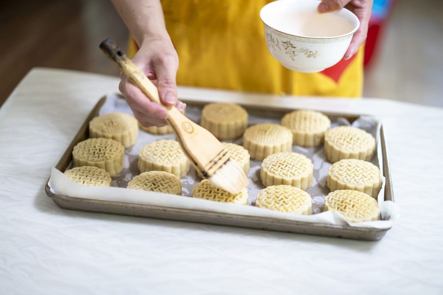 An image of a woman making moon cakes.