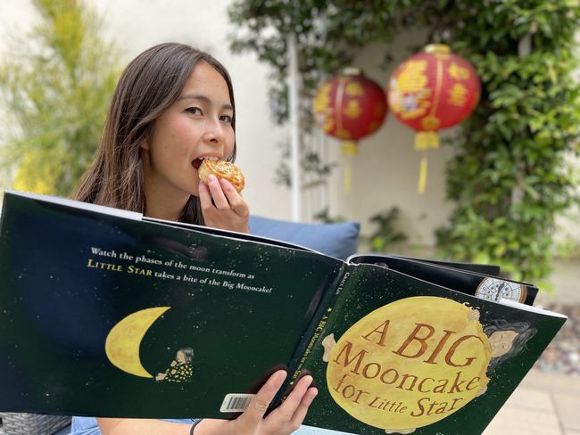 The author's daughter eating a mooncake.