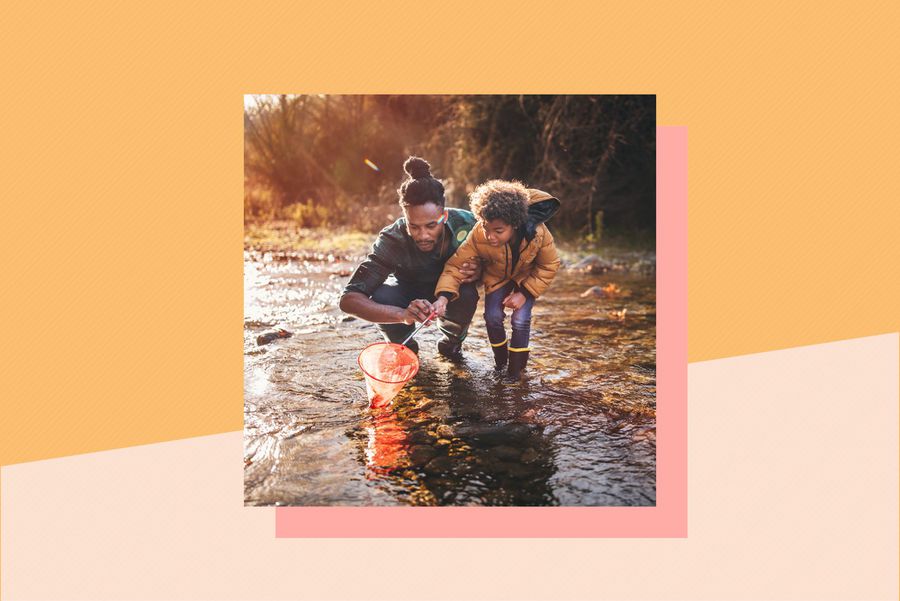 Father and son fishing with fishing net in river