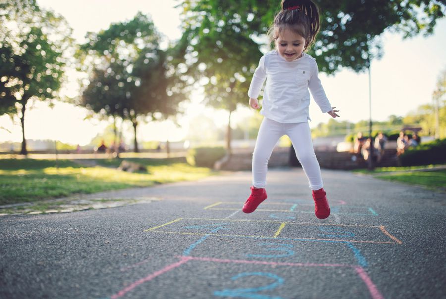 Jumping child playing hopscotch