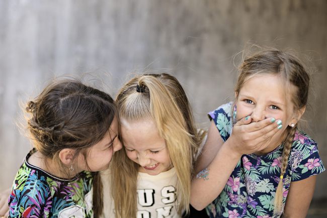 An image of three girls laughing.