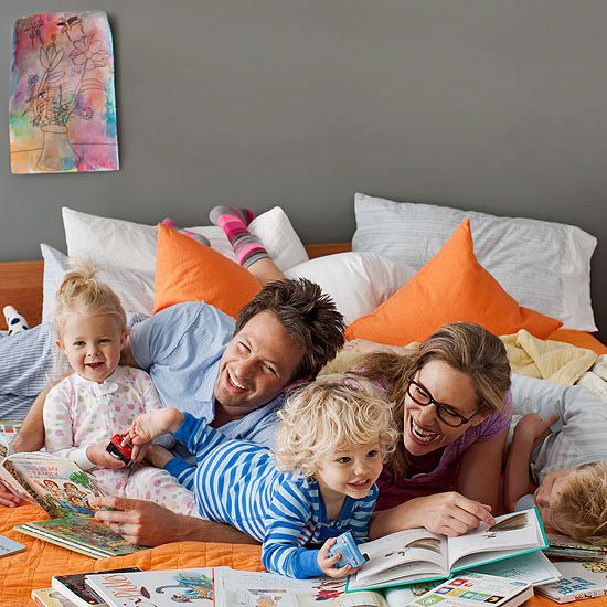 family in bed reading