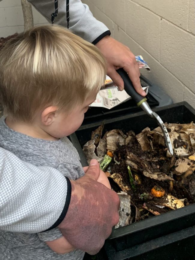 The author's son and husband and their worm farm.