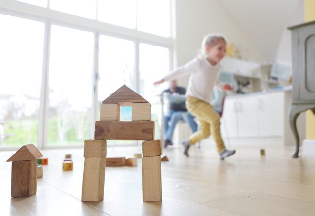 Family at home child playing with building blocks