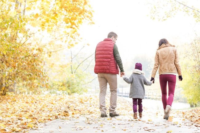 Family practicing mindfulness walking in the woods