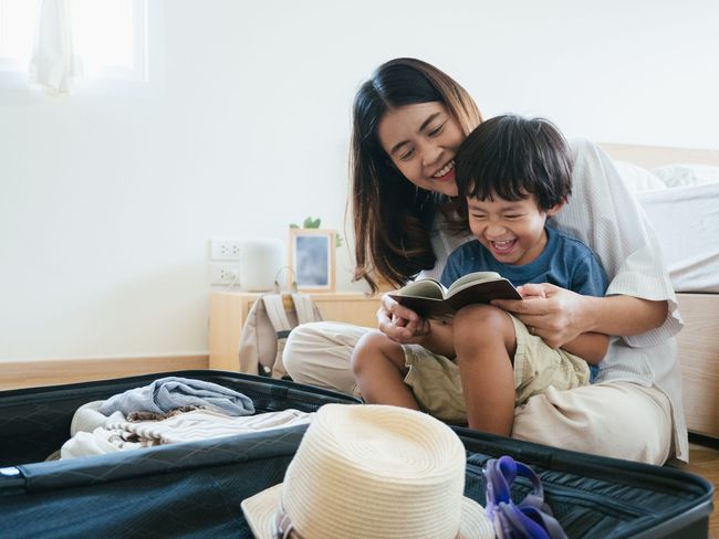 An image of a mother packing for vacation with her son.