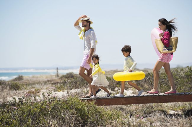 Family walking on a boardwalk on the beach