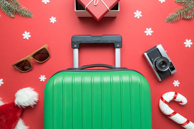 An image of luggage on a Christmas themed background.