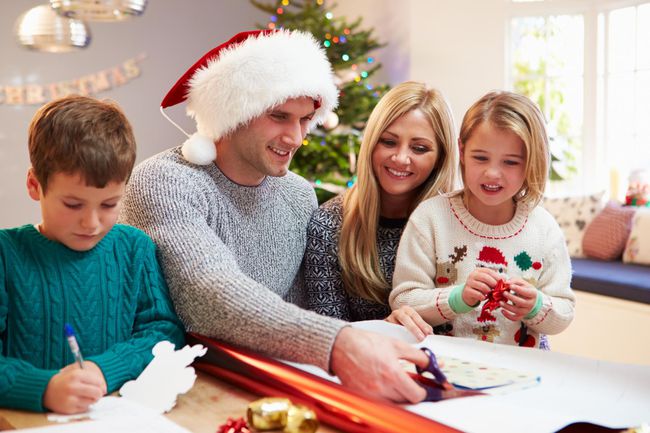 Family Wrapping Christmas Gifts At Home