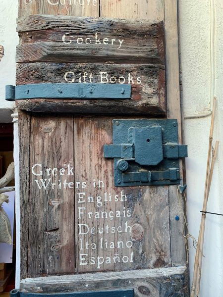 An old wooden door, with white writing on it.