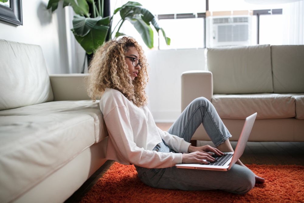 woman sitting at home on her laptop