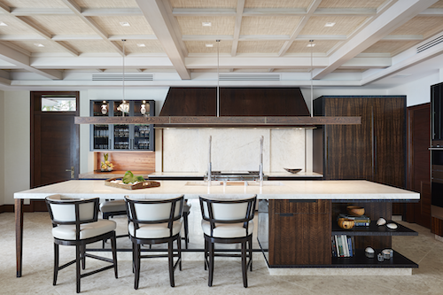 Modern kitchen with large island, dark cabinets and white countertops