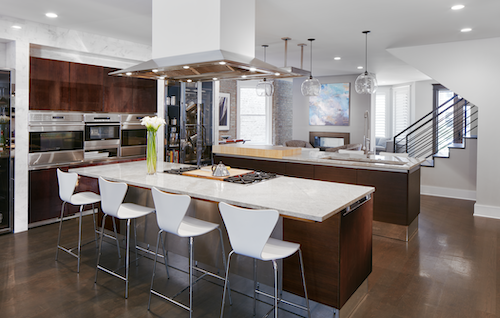 Modern kitchen with large island, dark cabinets and white countertops