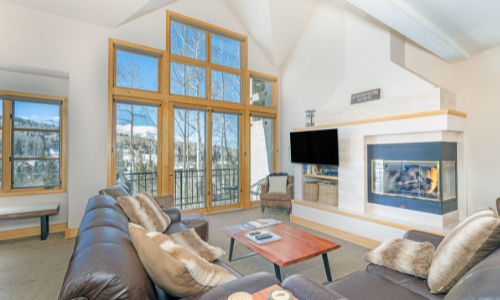 Inside a living space with a neutral color palette and large windows