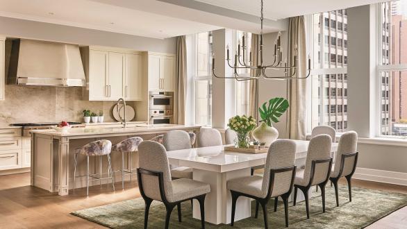 Staged dining area with full back chairs in cream colors and a white table