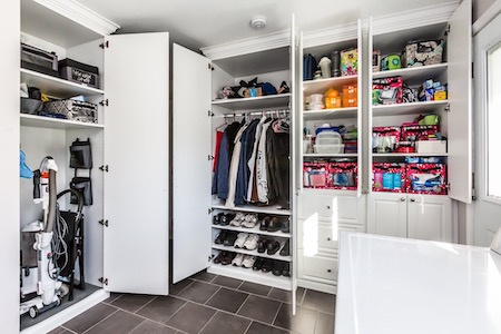 Large storage cabinets in laundry room.