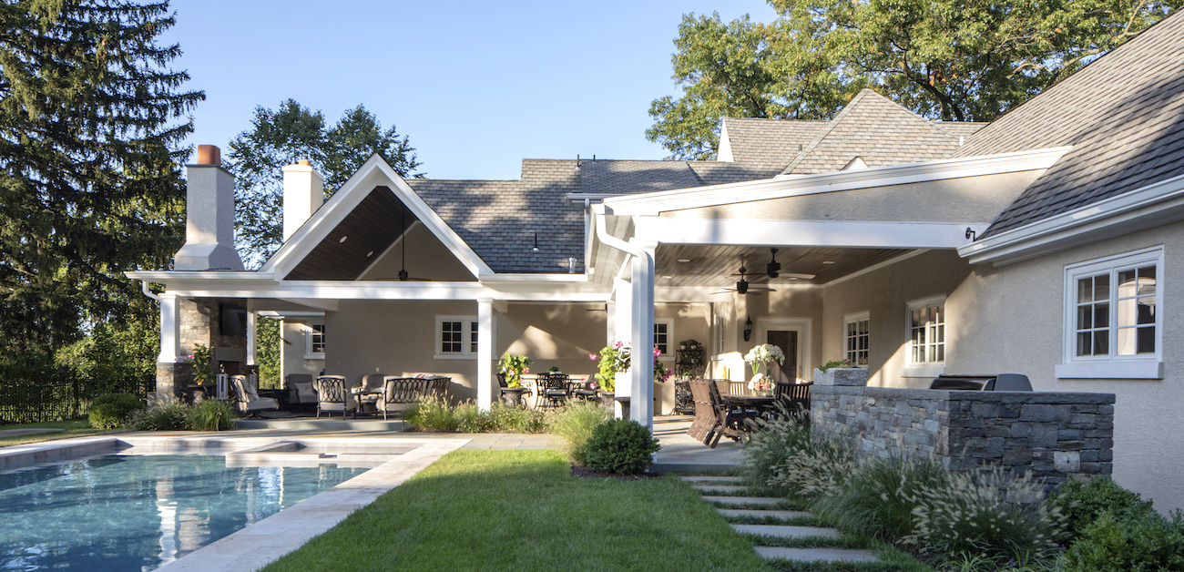 Backyard with lush lawn, landscaping, and pool.