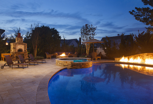 Backyard pool with fire pit and accents