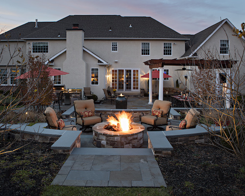 Ourdoor patio with firepit, seating, and pergola